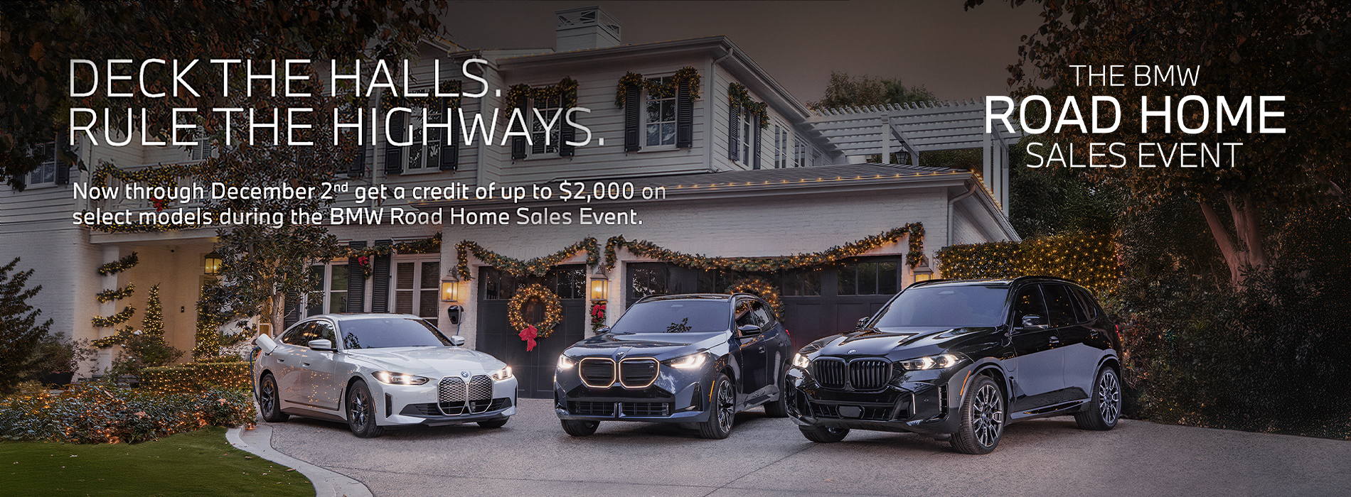 BMW i4, X3, and X5 parked in a driveway of a holiday decorated home.