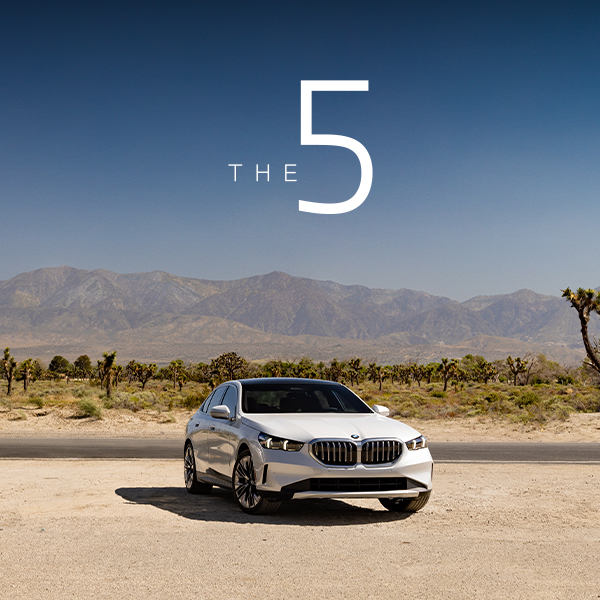 Parked BMW 5 Series in desert landscape