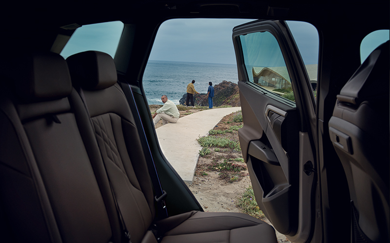 The backseat of a BMW X3 with a beach background.