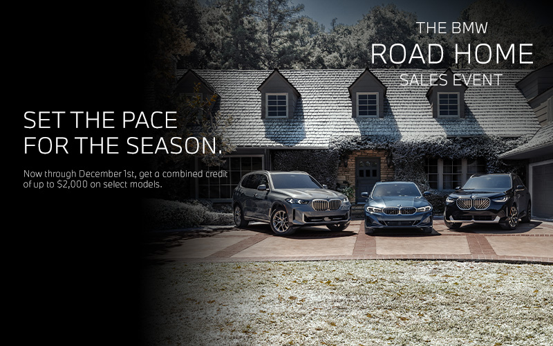 BMW X5, 3 Series, and X3 parked in a driveway of a holiday decorated home.