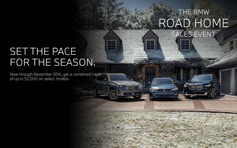 BMW X5, 3 Series, and X3 parked in a driveway of a holiday decorated home.