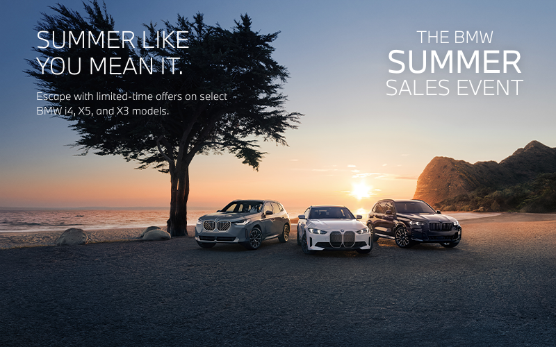 BMW X3, i4, and X5 parked near seaside.