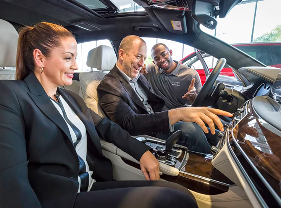 A BMW Genius worker showing the interior of a BMW.