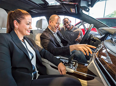 A BMW Genius worker showing the interior of a BMW.