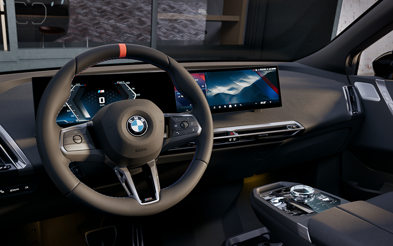 Interior steering wheel and dashboard of the BMW iX M70.