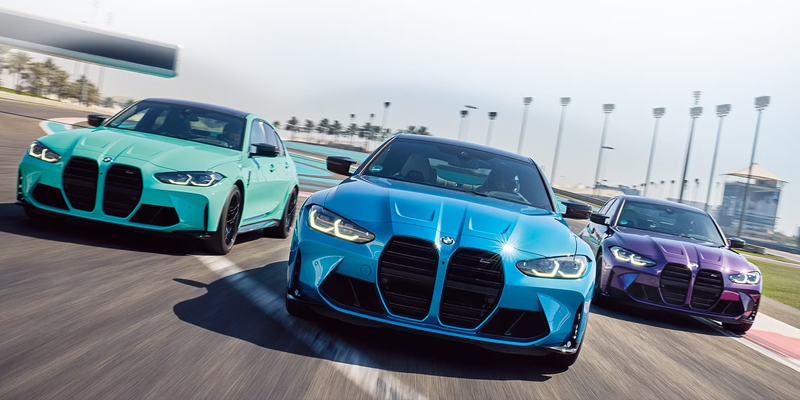 Three BMW M Cars racing down a track.