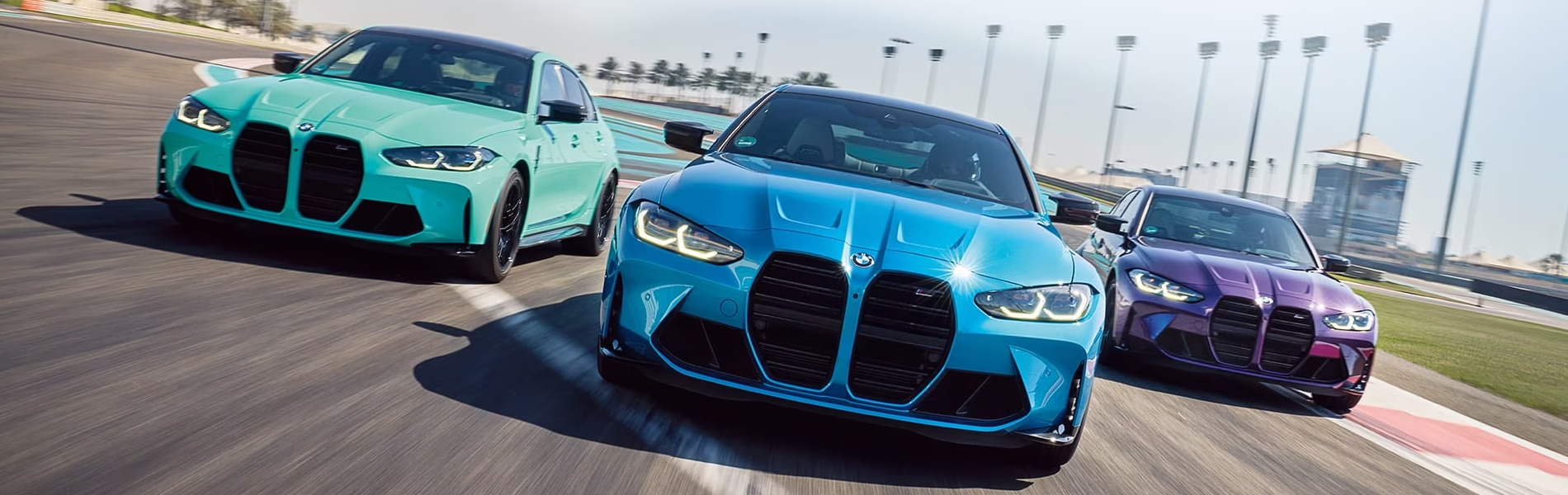 Three BMW M Cars racing down a track.