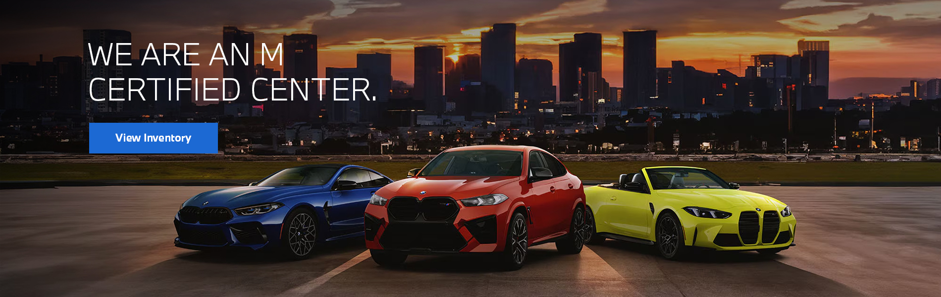  Colorful BMW M vehicles parked with a city skyline background.