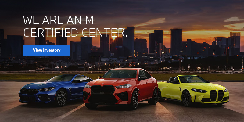  Colorful BMW M vehicles parked with a city skyline background.