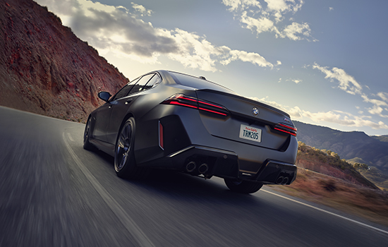 BMW M5 driving rear shot.