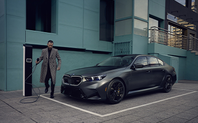 Man charging BMW M5.