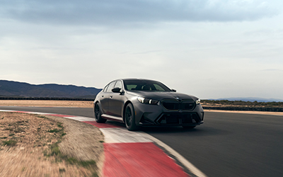 BMW M5 driving around a corner.