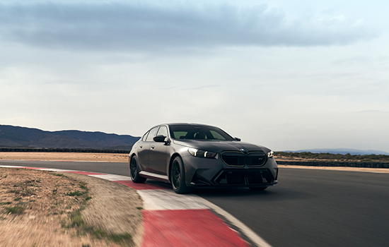 BMW M5 driving around a corner.