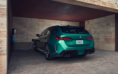  The BMW M5 Touring charging in a garage.