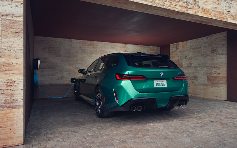  The BMW M5 Touring charging in a garage.