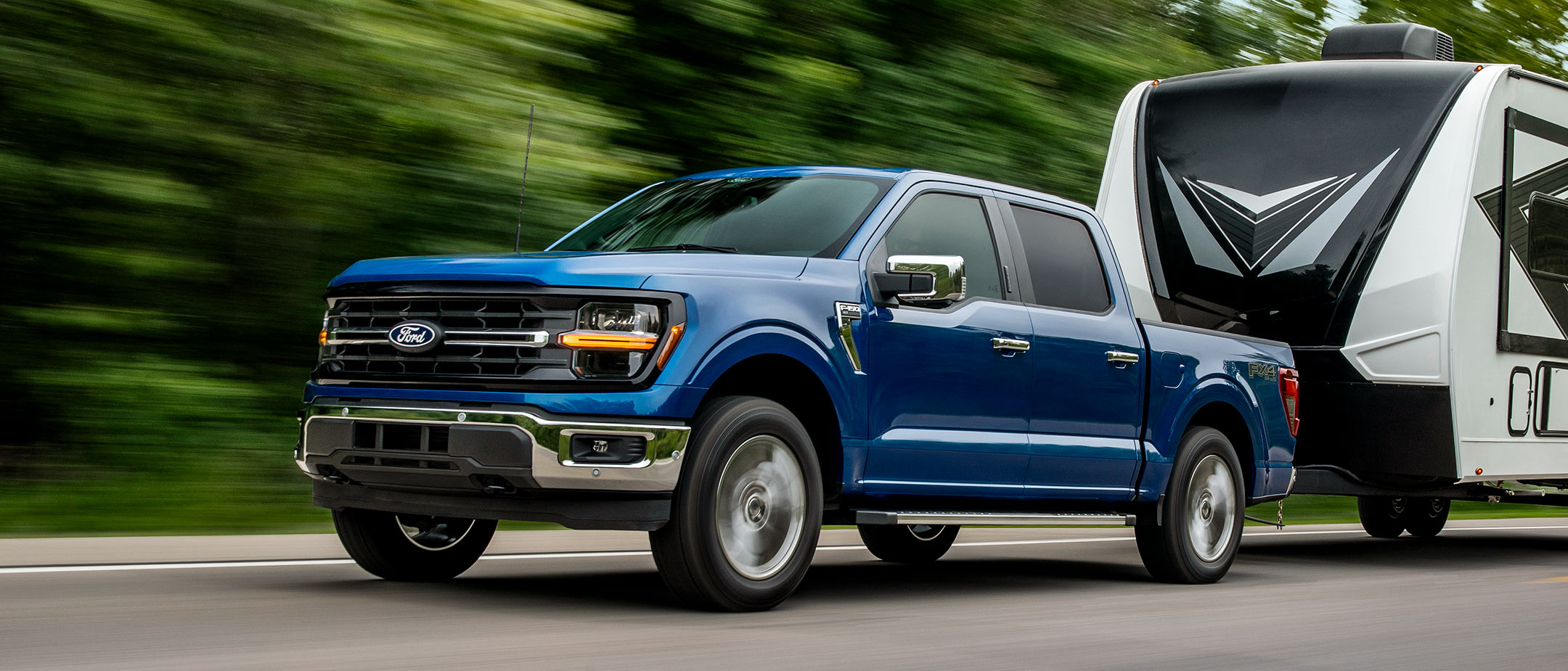 2025 Ford F-150® pickup towing camper.
