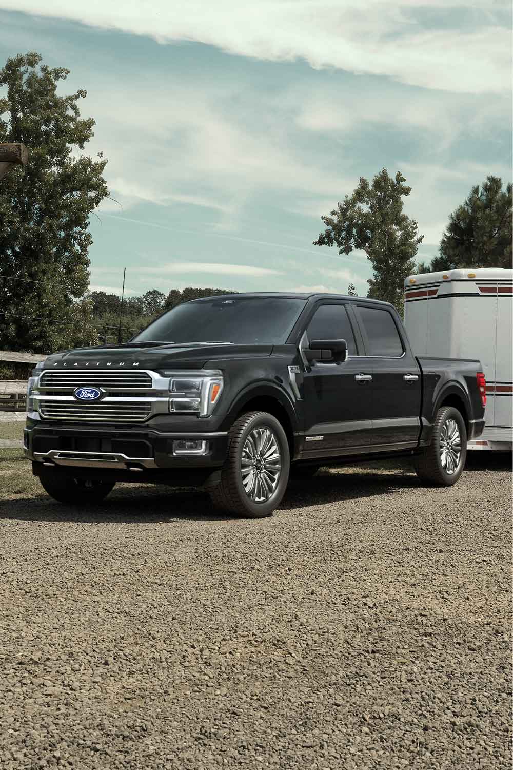 2025 Super Duty® hitched to a horse trailer with a horse and person at the back.