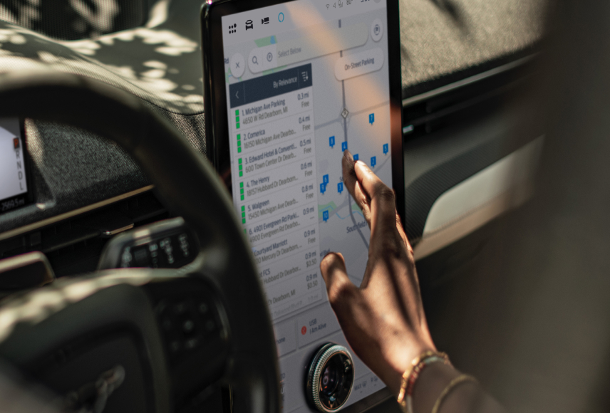 A Ford vehicle technology screen shows multiple locations listed and pinpointed on Google Maps. Screen may vary.