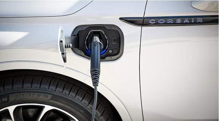 An electric charger is shown plugged into the charging port of a Lincoln Corsair® Grand Touring model.