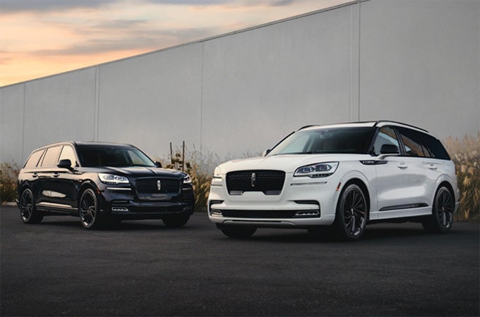 Two Lincoln Aviator® SUVs are shown with the available Jet Appearance Package