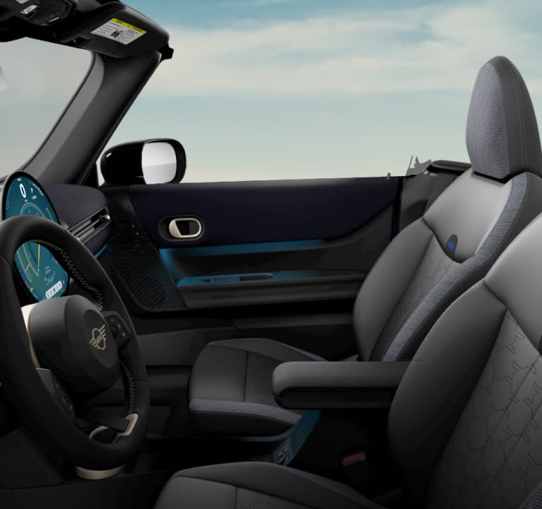 The front of the MINI Cooper S Convertible’s
        cabin, taken from the driver’s side, with a focus on the
        Sports Seats and steering wheel.