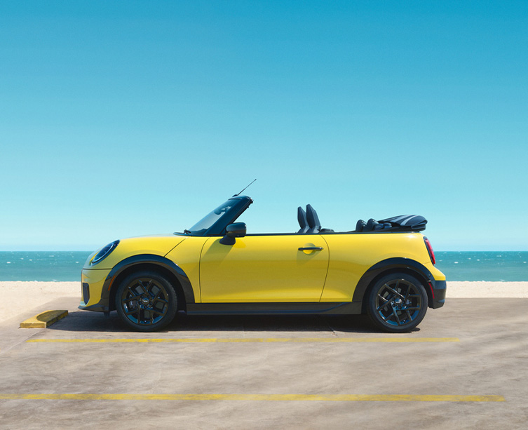Side profile shot of sunshine yellow MINI Cooper Convertible.