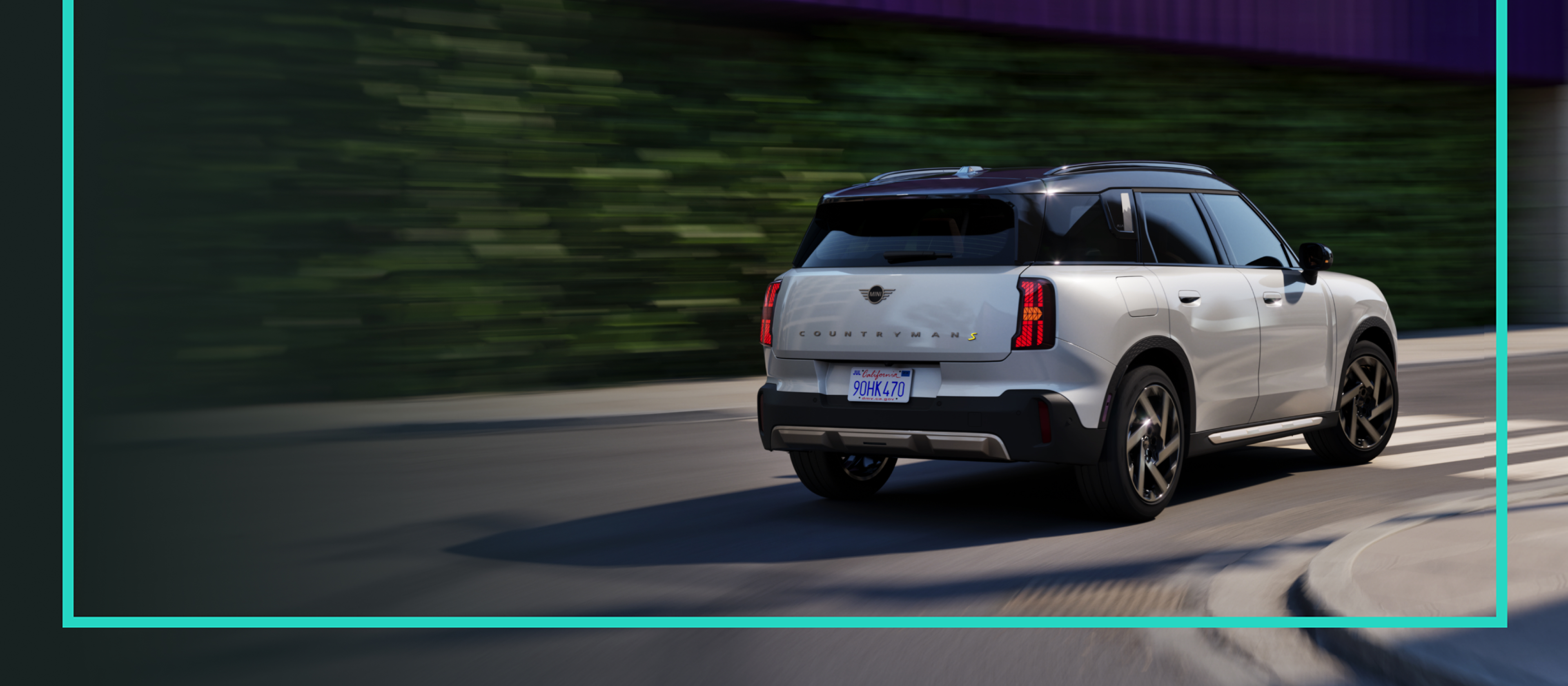 A MINI Countryman SE ALL4 cruises down a road.