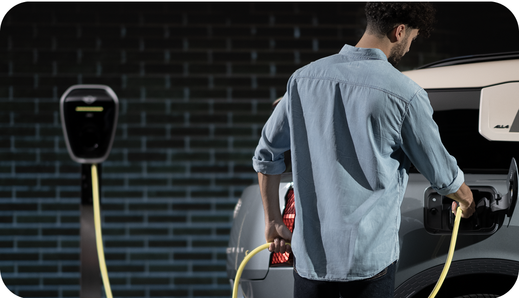 A man charges his MINI Countryman SE ALL4.