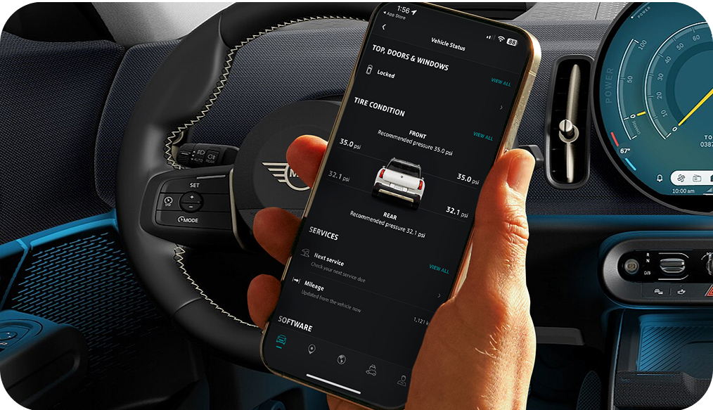 A hand holding up a phone open to the MINI App.
