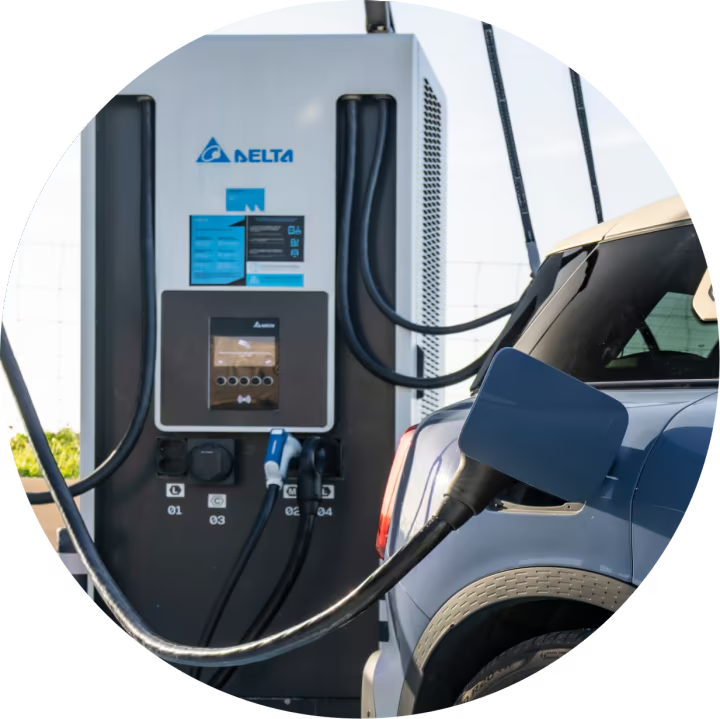 Side view of the rear of a MINI recharging at a public charging station.