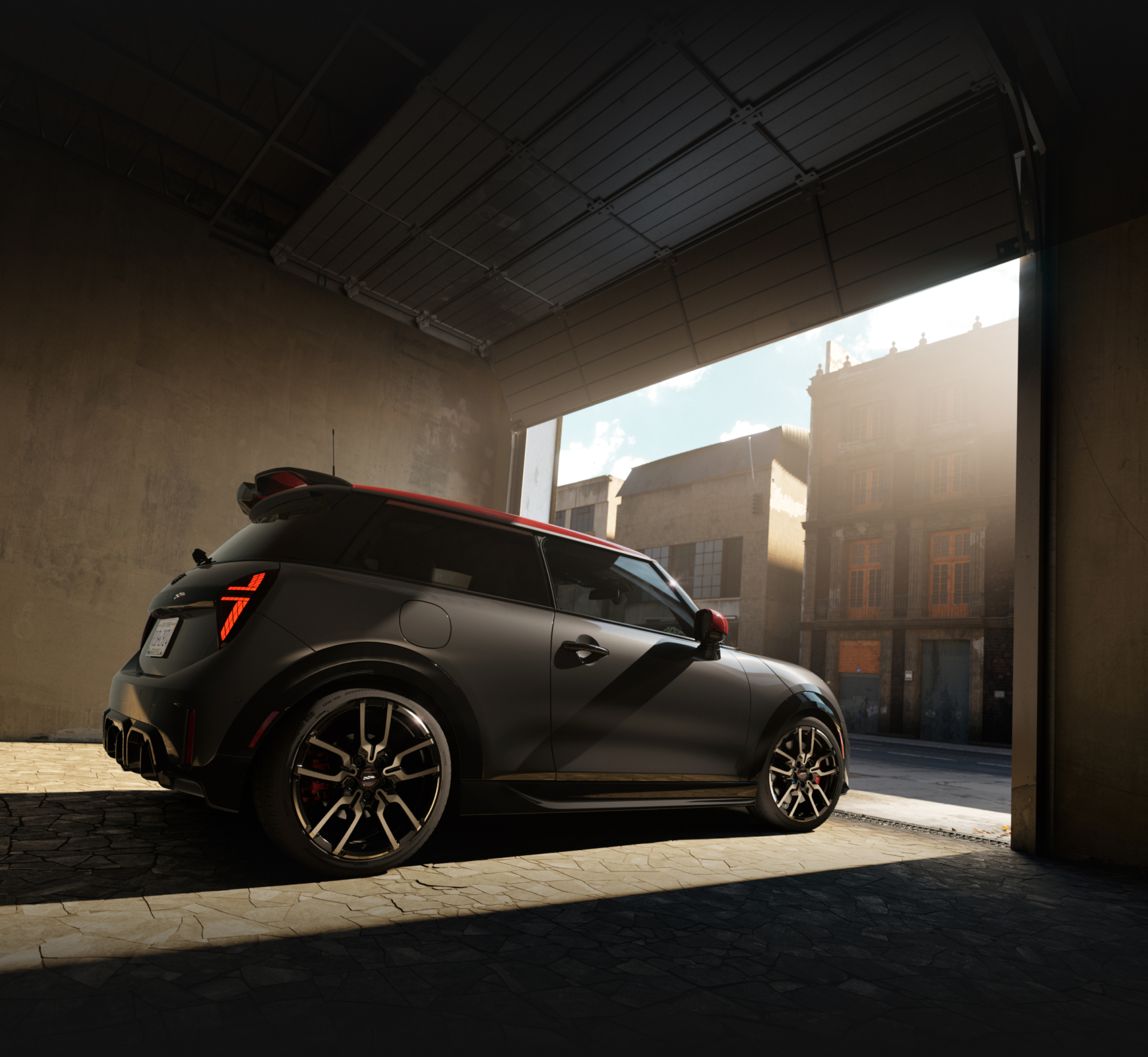 The MINI JCW 2 Door exiting a dark garage.