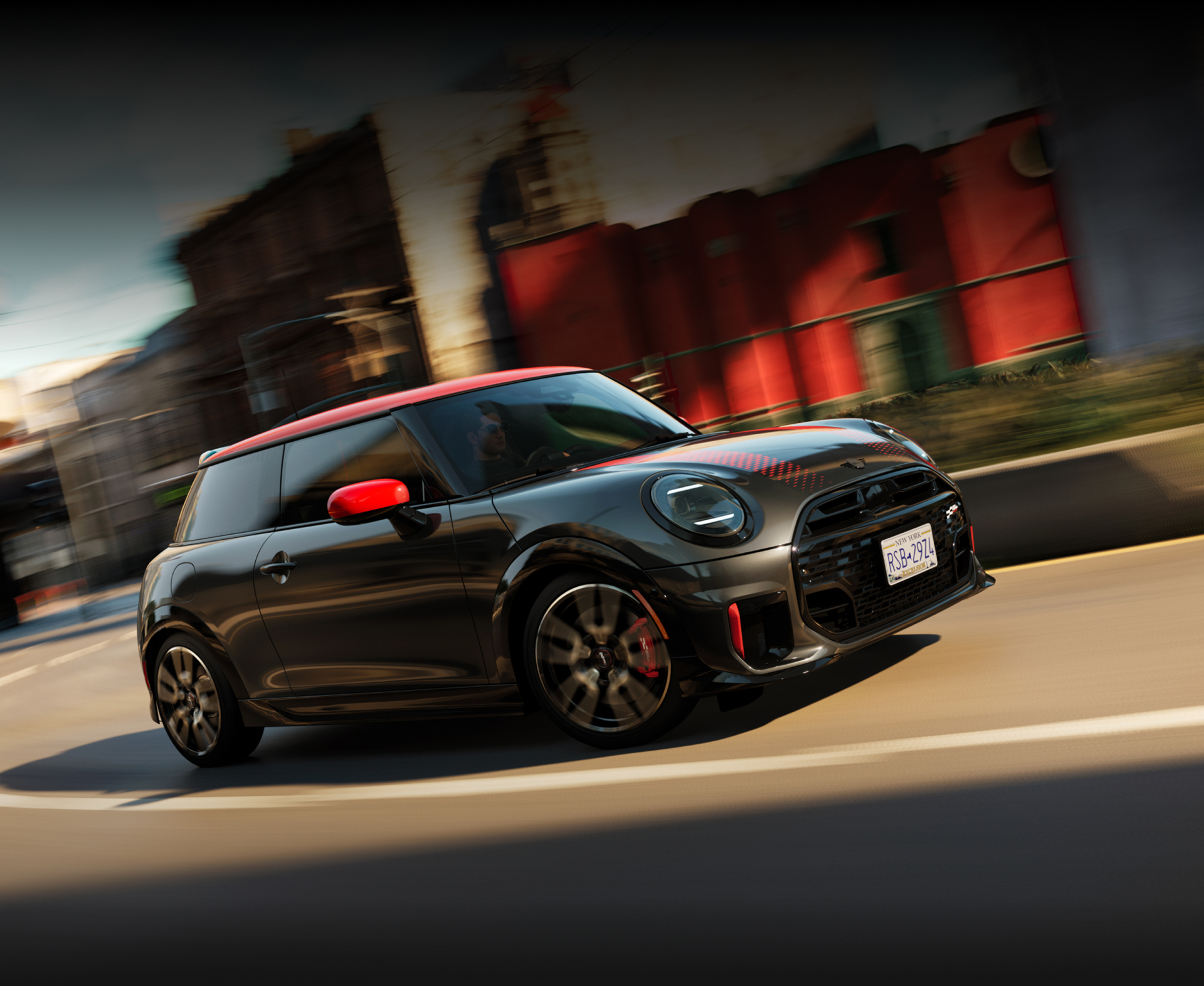 A MINI JCW 2 Door zooms around a bend.