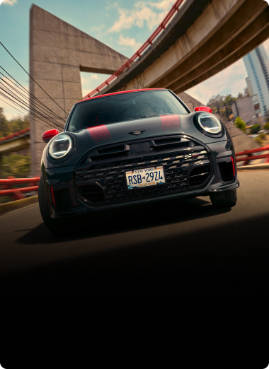 Low-angle, front view of a MINI JCW 2 Door while driving.