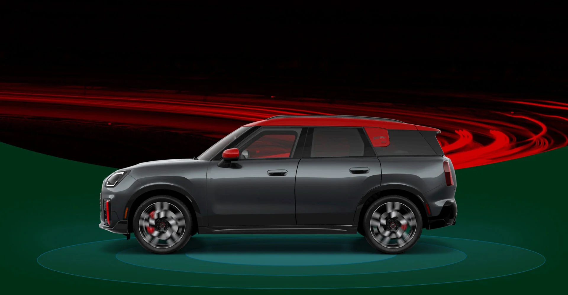 The side-view of a 2025 MINI JCW Countryman ALL4 with blue rings beneath it against a background of red and black rings.