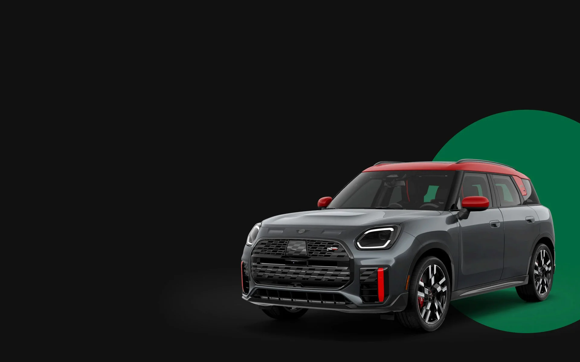 Angled front-to-rear view of the MINI JCW Countryman ALL4 in front of a green circle with a black background.