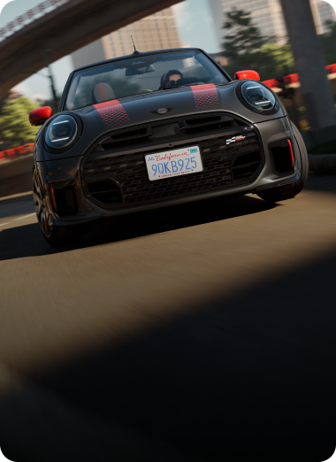 Low-angle, front view of a MINI JCW Convertible while driving.
