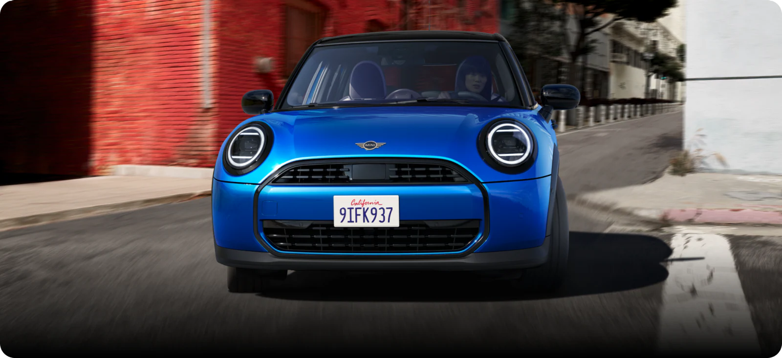 Front-view of the 2025 MINI Cooper Oxford Edition driving.