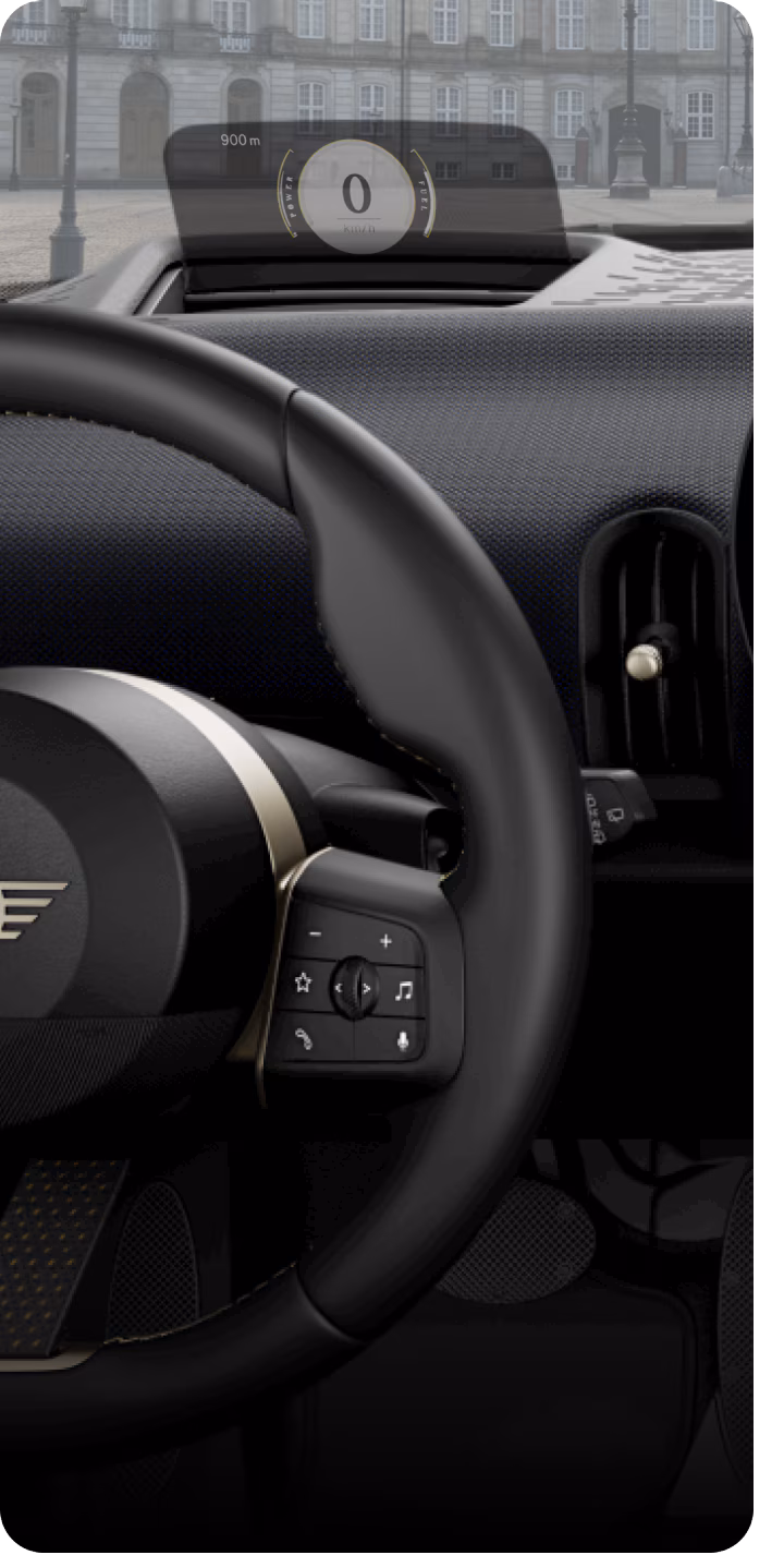Close-up of the MINI Head-Up Display and steering wheel.