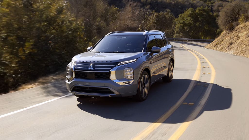 Front shot of the 2026 Outlander PHEV on a scenic road