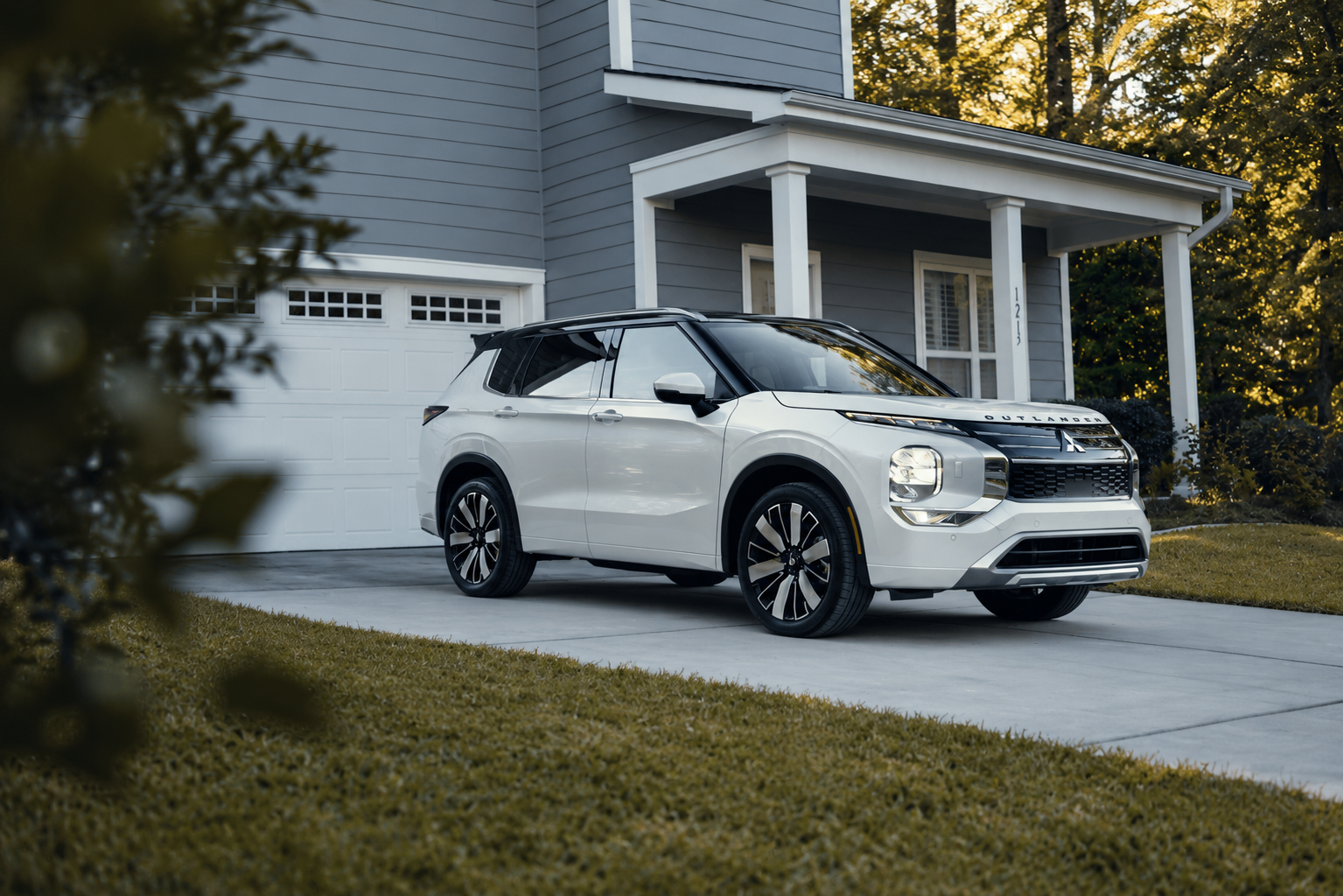 Still shot of a silver 2026 Outlander in a driveway