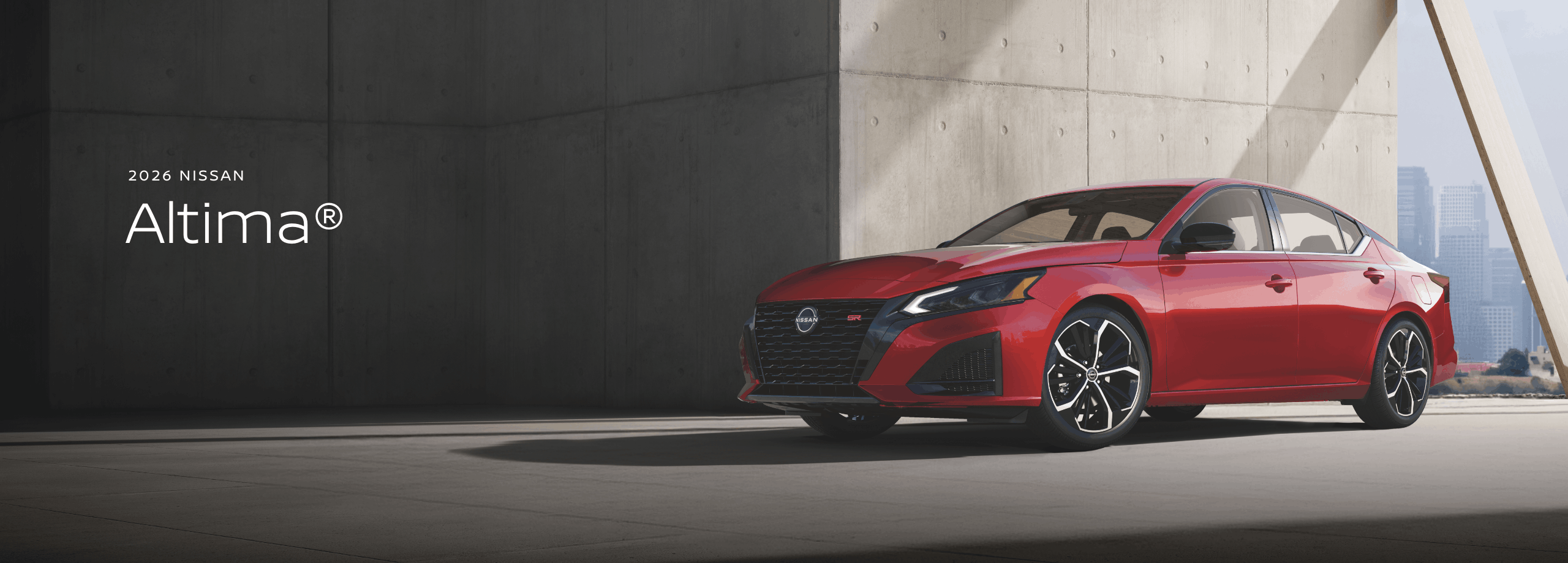 2026 Nissan Altima driving through the desert scrub on a dirt road