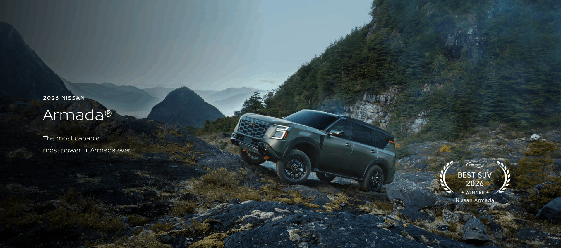 2026 Nissan Rogue driving through the desert scrub on a dirt road