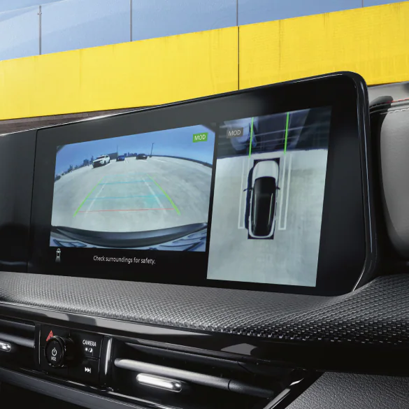 2026 Nissan Kicks on the highway in a bird's-eye view, with a blue schematic overlay demonstrating ProPILOT Assist feature.