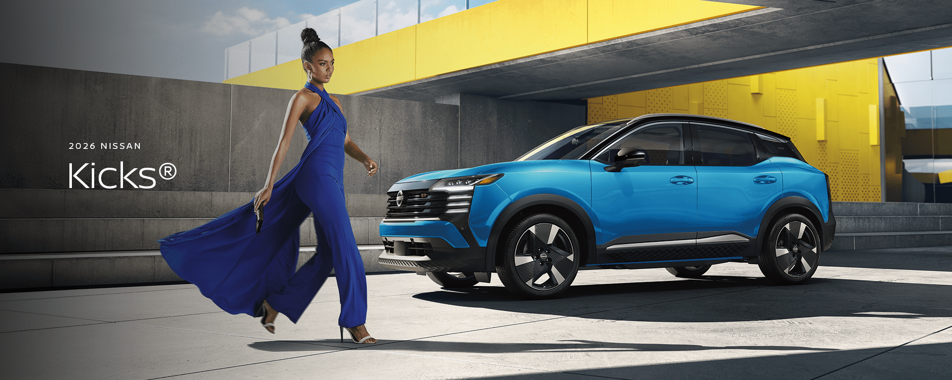 2026 Nissan KICKS in blue parked on a rooftop with modern building the background