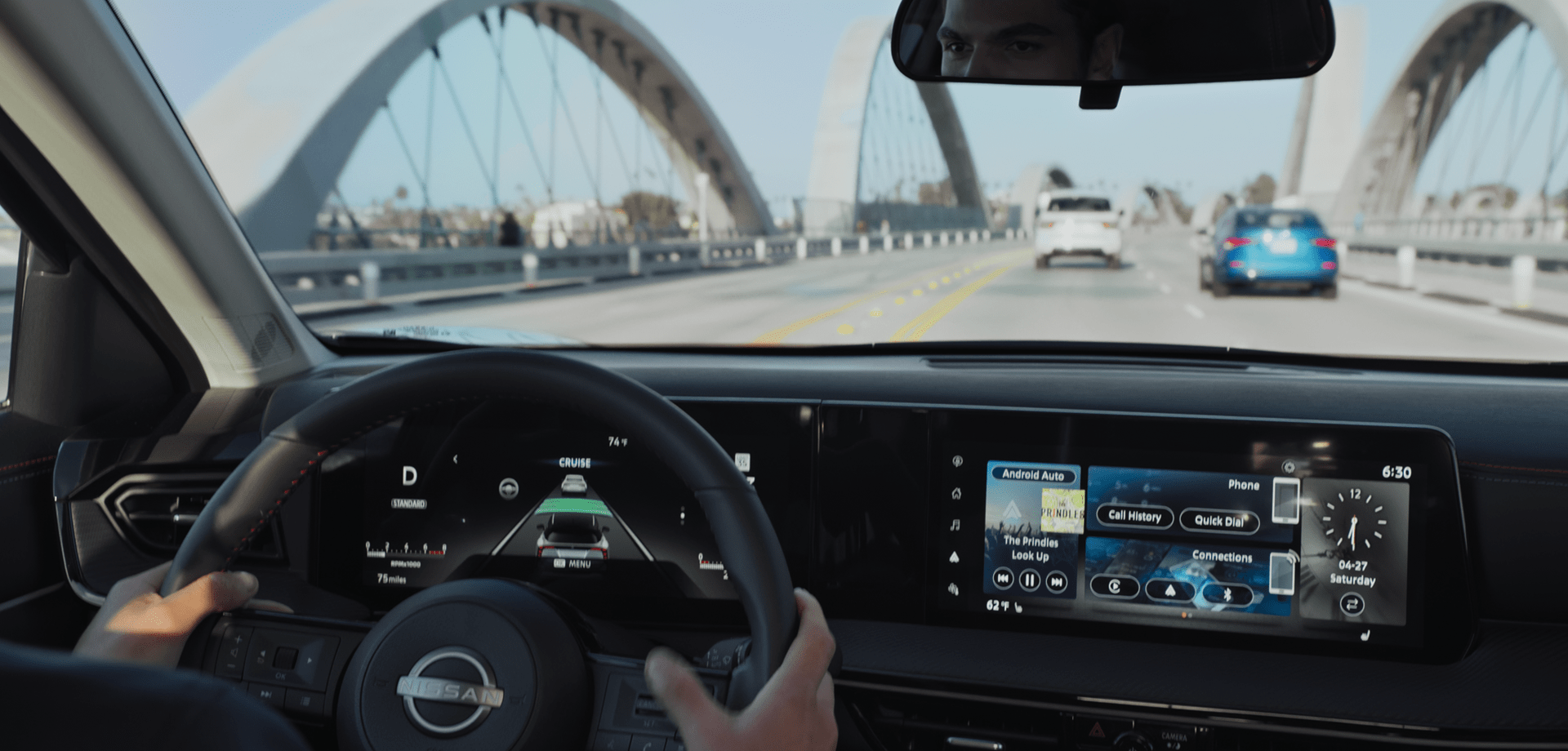 2026 Nissan LEAF in blue parked on a rooftop with modern building the background