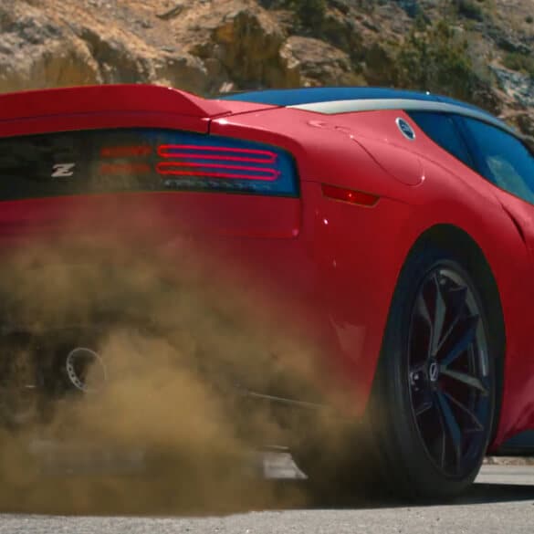 2026 Nissan Z in red, rear 3/4 low view kicking up dirt