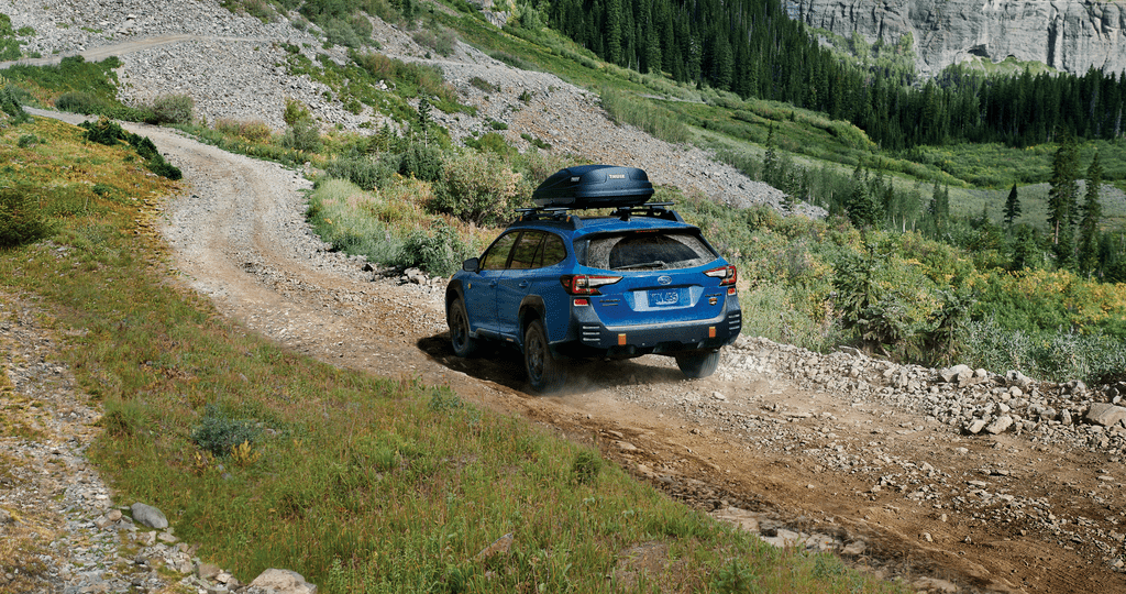 A 2023 Outback Wilderness driving on a trail in the mountains.