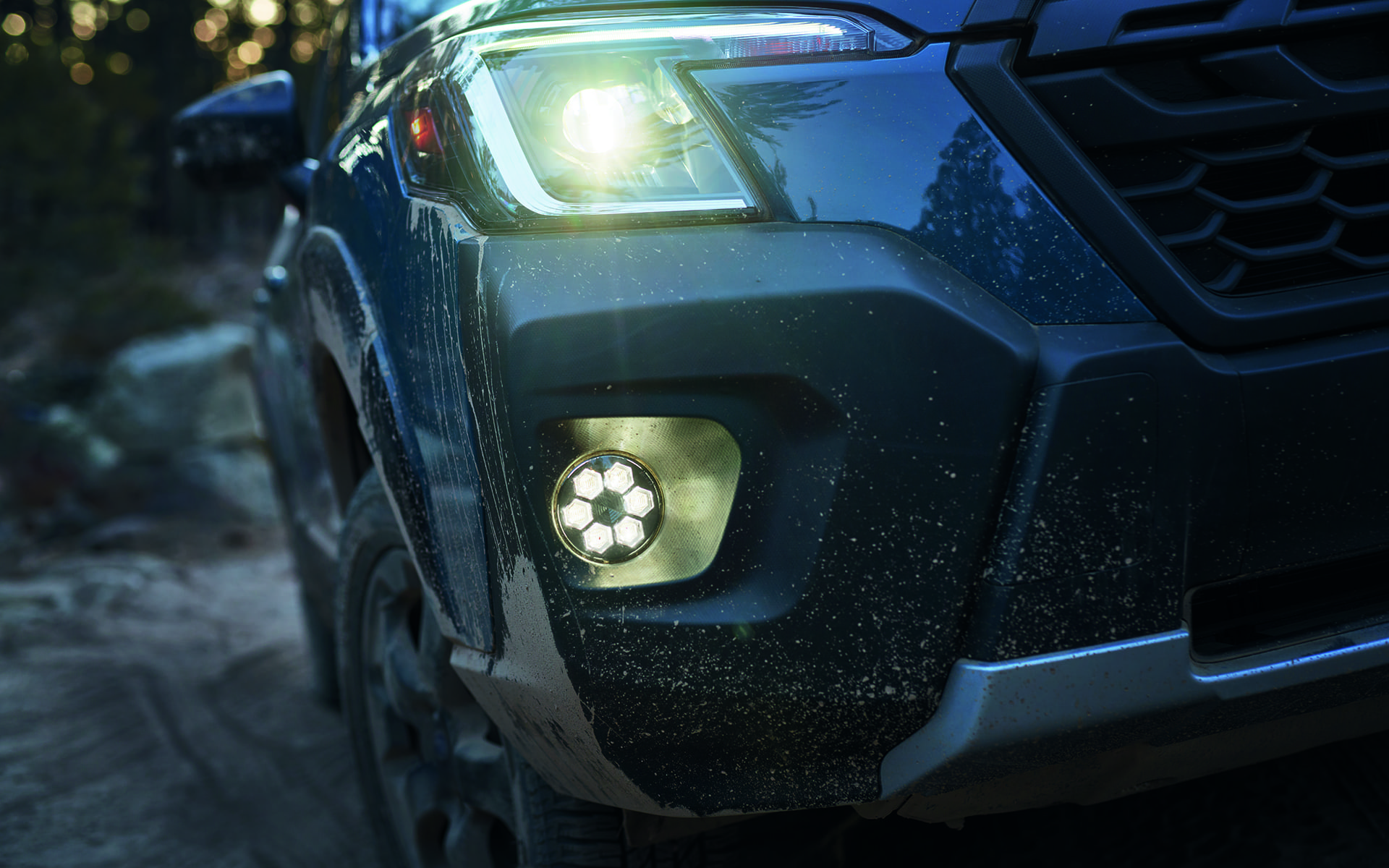 Close up of right headlight turned on at night