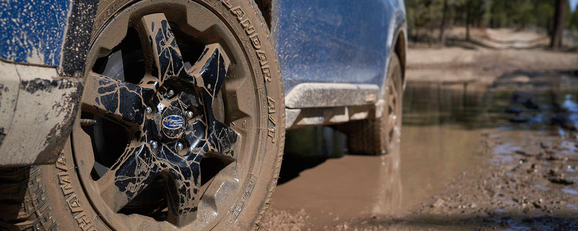 Close-up of muddy Subaru off-road wheels on Forester Wilderness