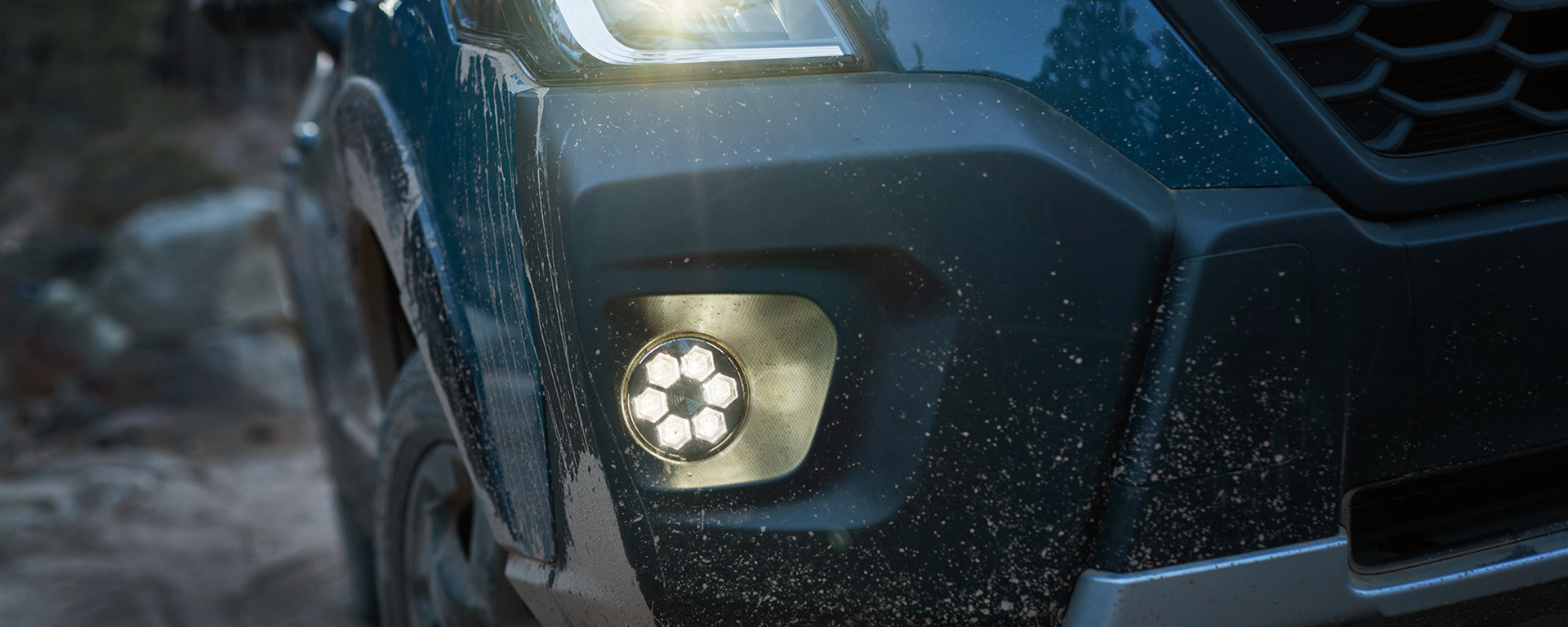 Close-up of right headlight turned on at night